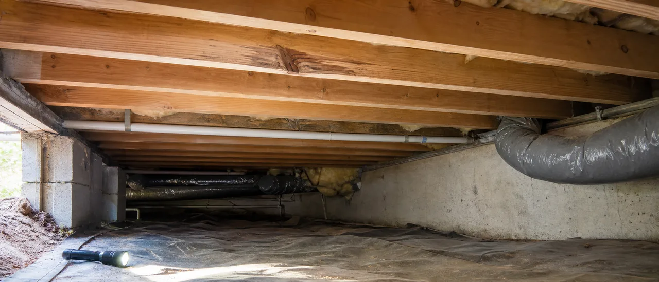 Exposed residential floor joists viewed during a crawlspace inspection